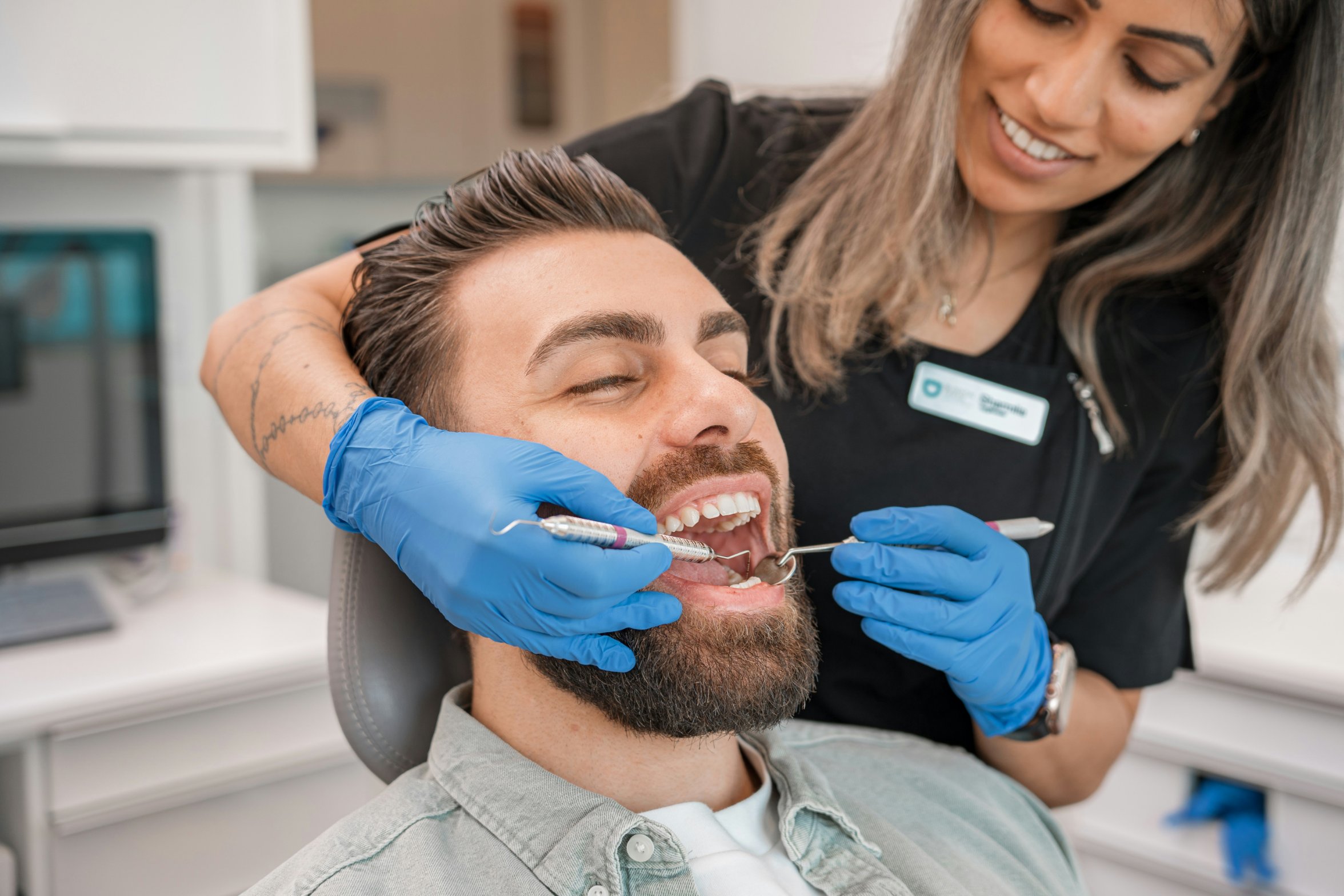 A dental hygienist examining a patient's teeth